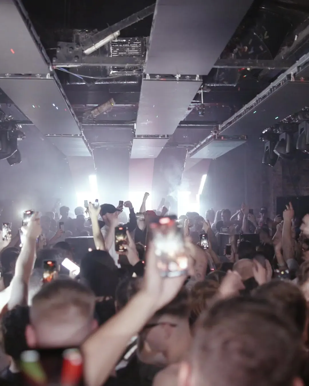 DnB Allstars 360: Leeds: hands and phones up as white beams cut through the Leeds crowd