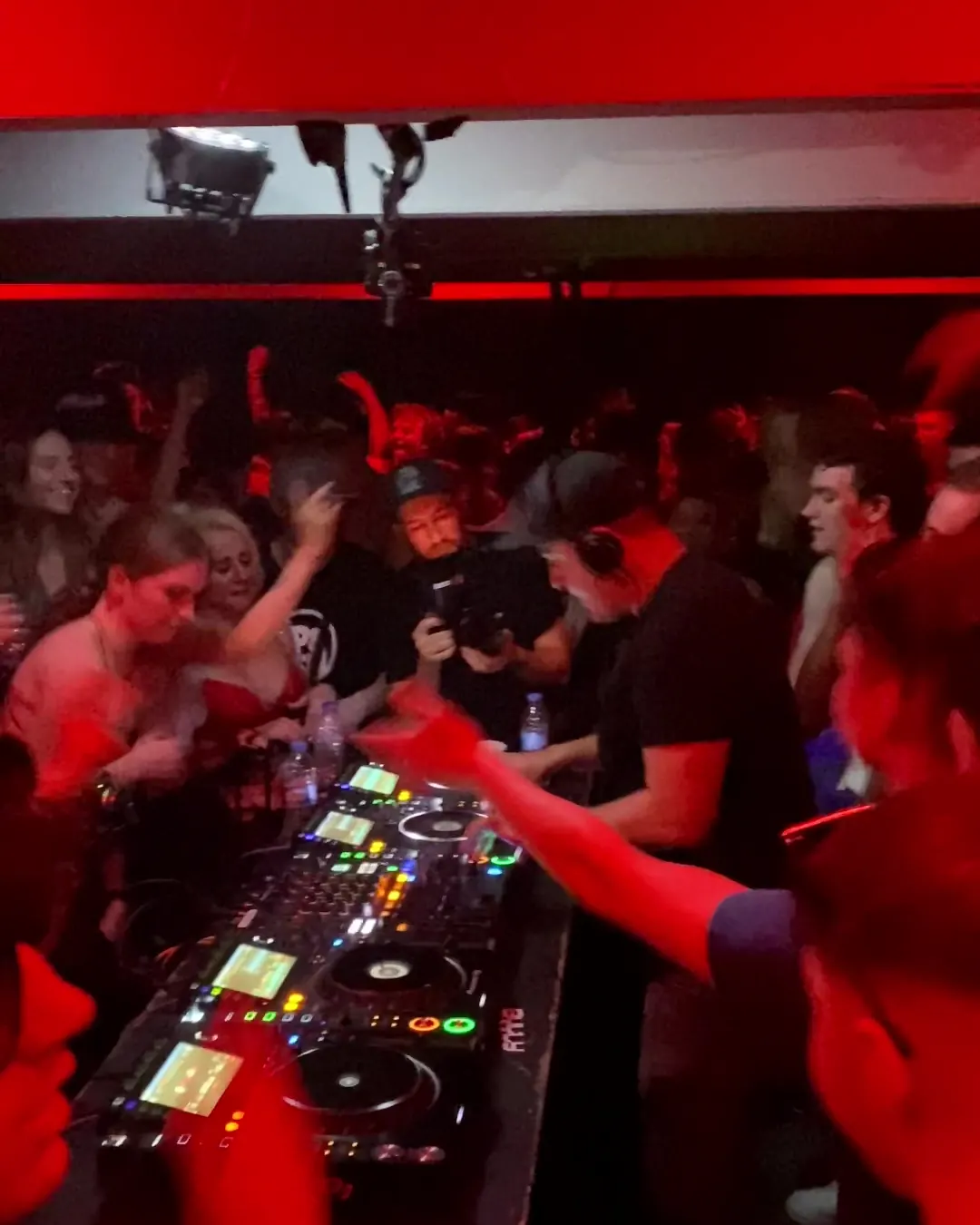 DnB Allstars 360° w/ Break: red-lit crowd leaning in over the 360 booth