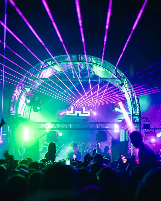 DnB Allstars 360 x 30Hz: Bristol: Purple laser fan over the lit arch stage and dnb logo, packed crowd