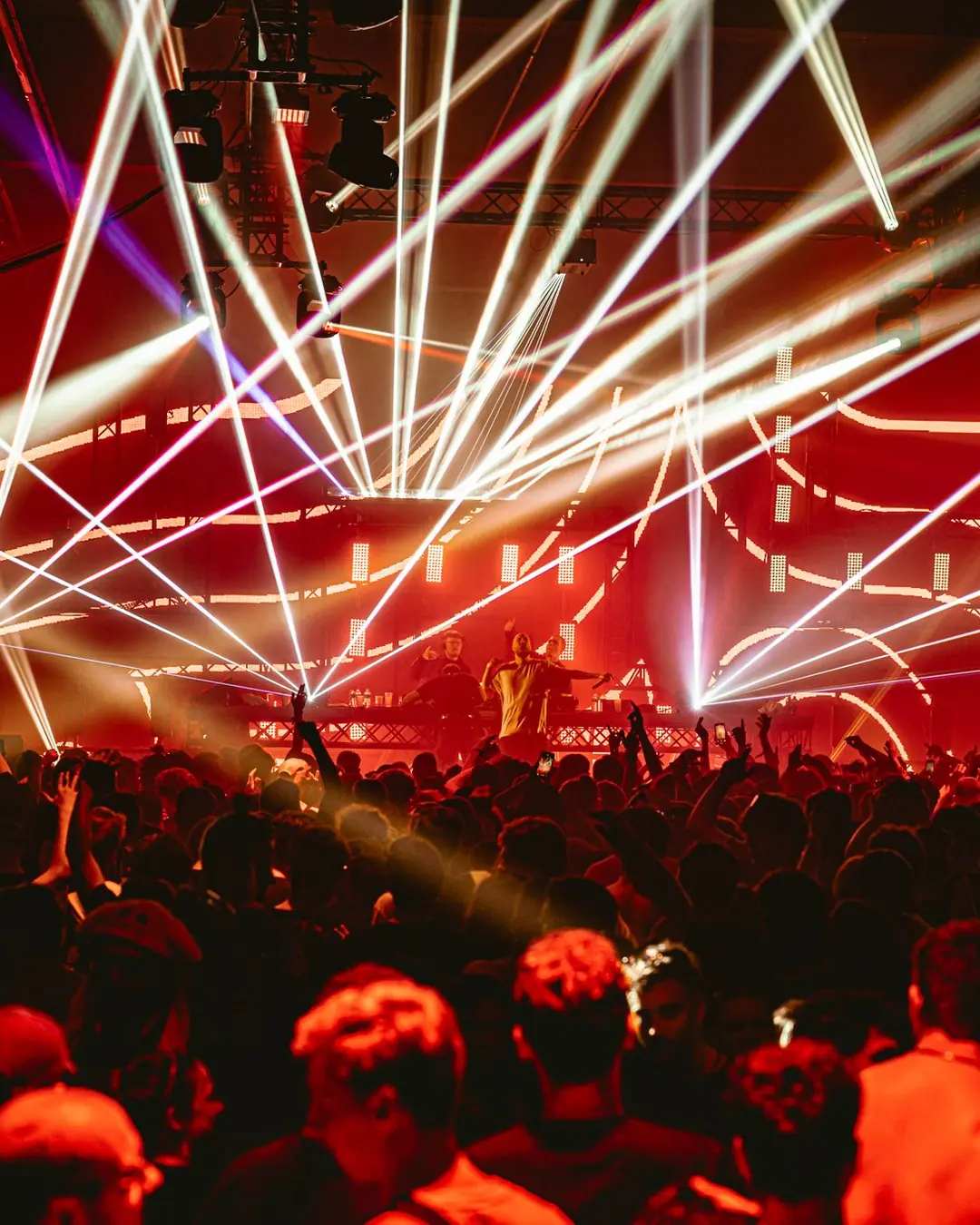 DnB Allstars: Belgium: Red and white lasers explode over the crowd, raw large-hall energy