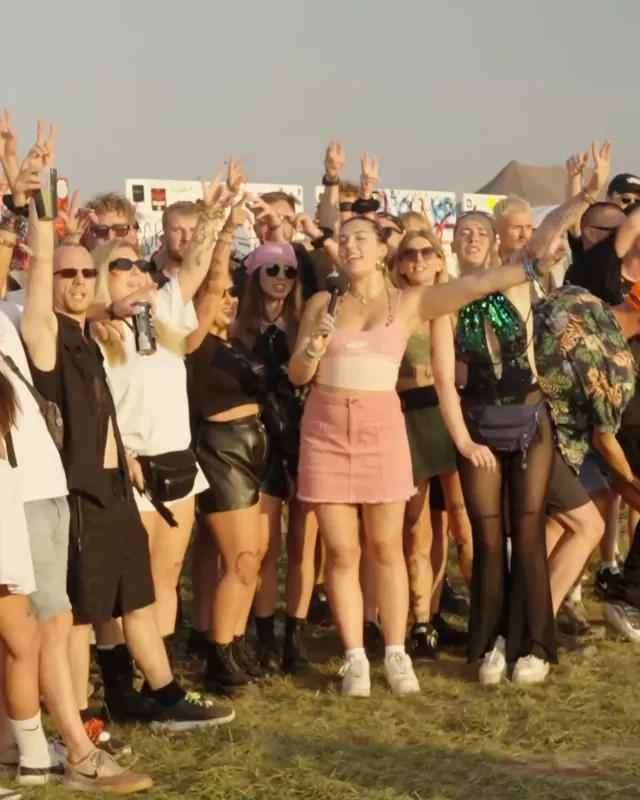 DnB Allstars at Let It Roll: festival crowd with hands up in the sun at Let It Roll
