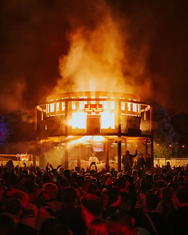 DnB Allstars Festival 2023: Fireball of pyro erupting behind the tower stage over a silhouetted crowd