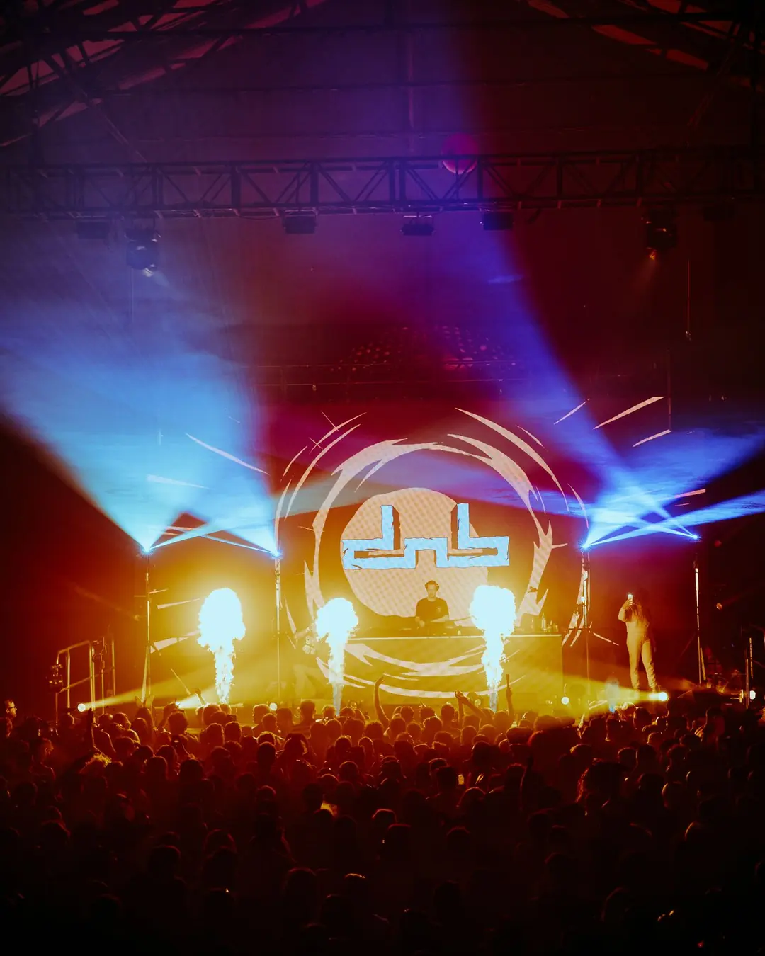 DnB Allstars Halloween: Birmingham: Halloween logo stage with pyro and blue beams over the crowd, says this show