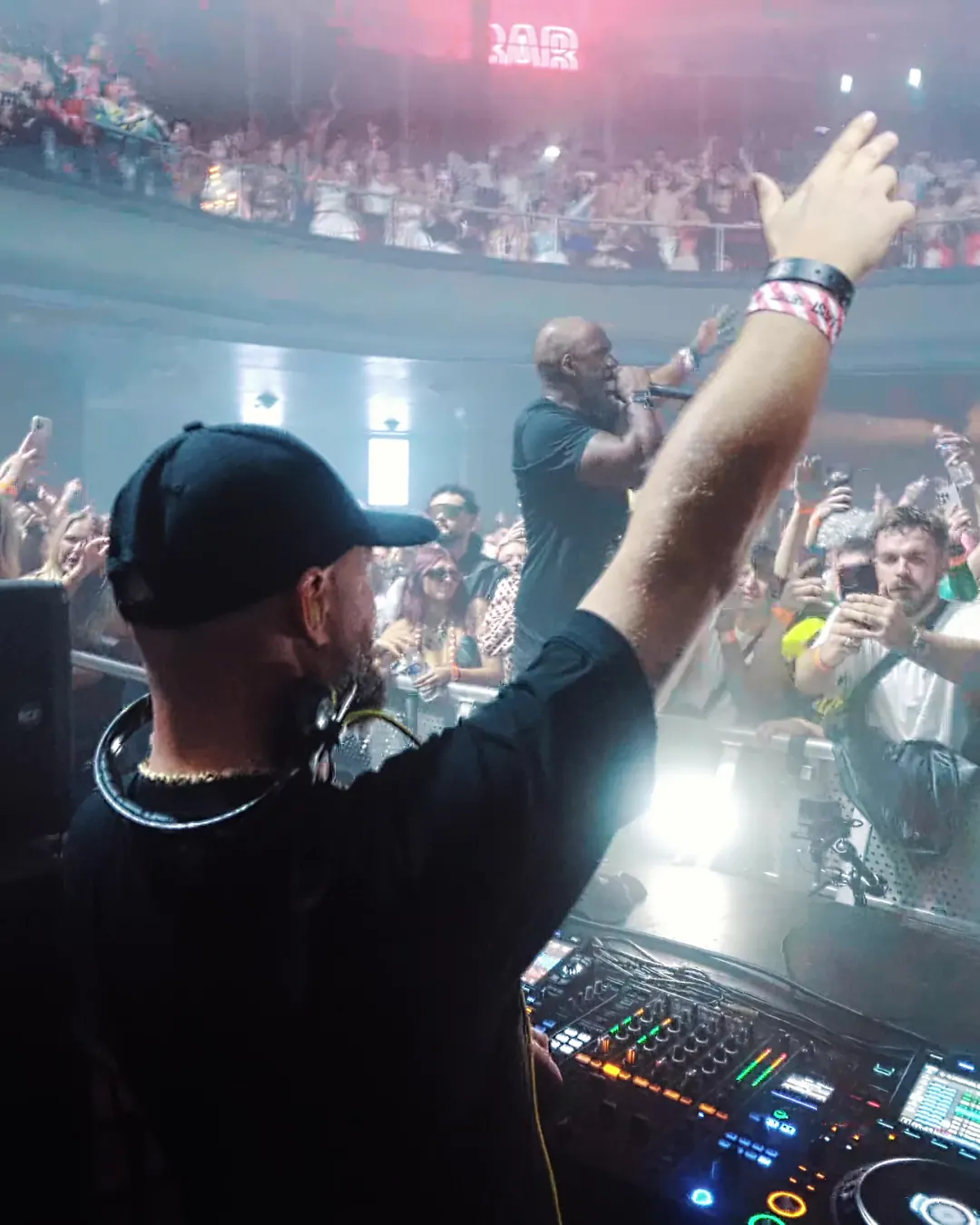 DnB Allstars Halloween: Liverpool: MC with his arm up at the front of the Liverpool crowd