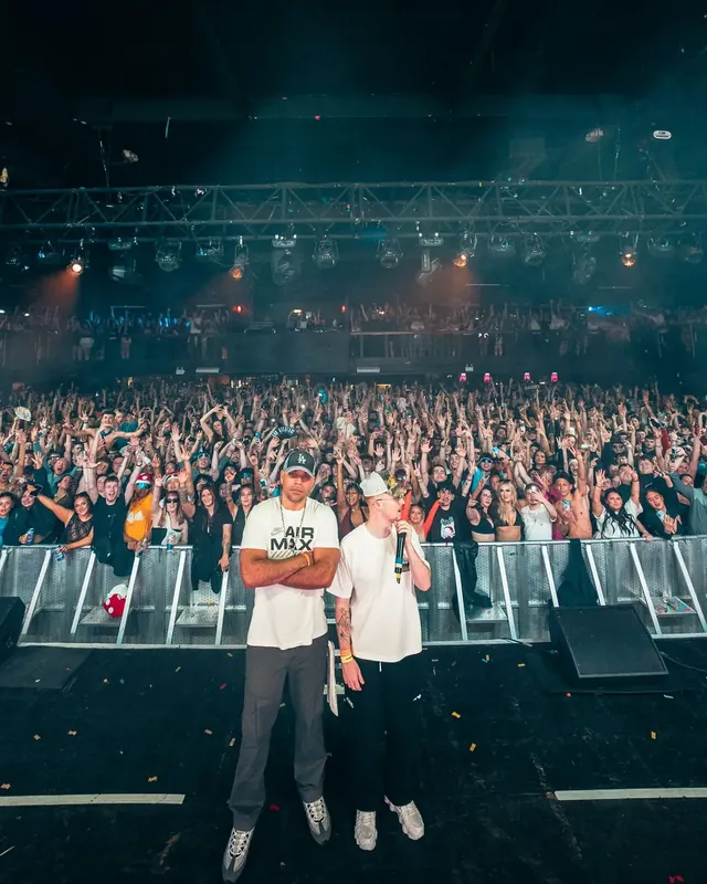 DnB Allstars NYE: Birmingham: Portrait version: stage-front pose with packed crowd and haze