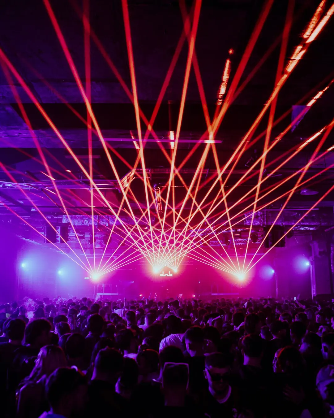 DnB Allstars NYE: Bristol: Purple-red laser fan exploding over a packed NYE crowd