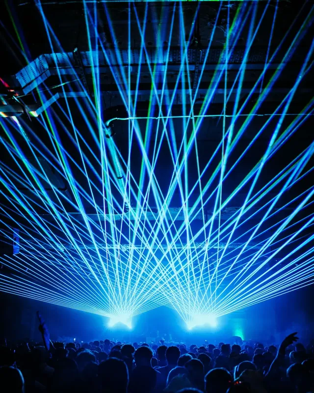 DnB Allstars NYE: Bristol 30Hz – The Final Underground Show: Symmetrical blue laser cage over the crowd, bold at card size