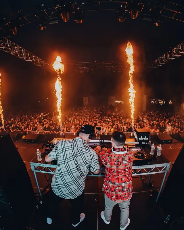DnB Allstars: Perth: DJs from behind, twin pyro columns, vast crowd ahead