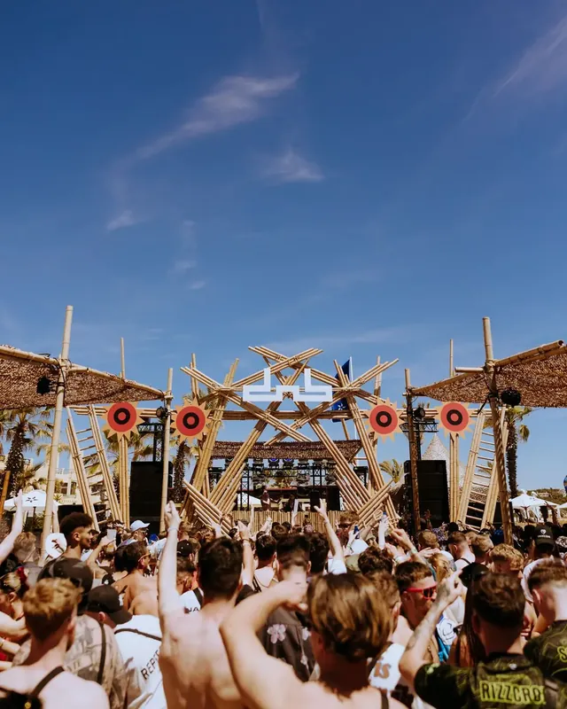 DnB Allstars Portugal 2024: Bamboo dnb main stage, deep blue sky, packed beach crowd
