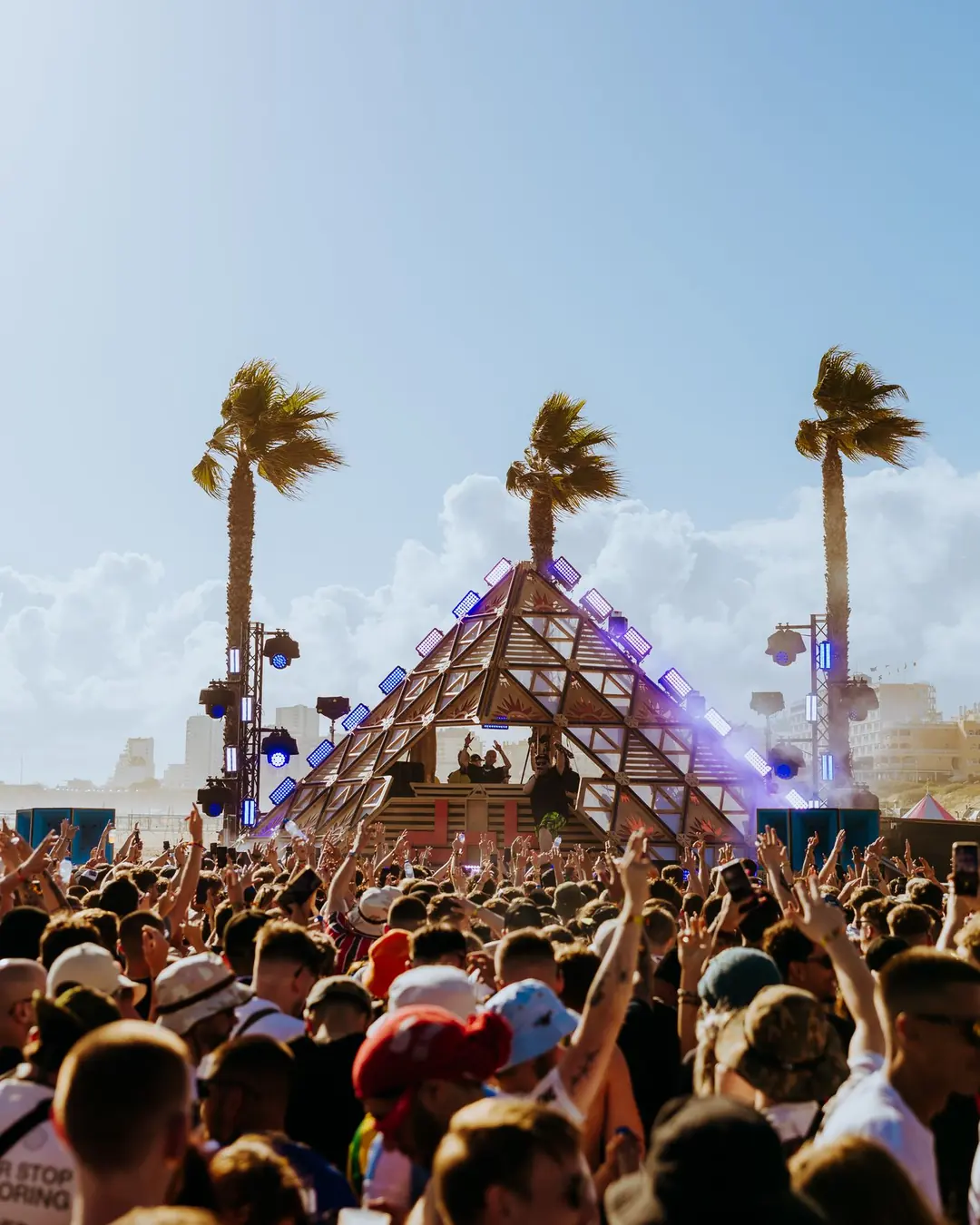 DnB Allstars Portugal 2025: Pyramid stage between palms, daylight crowd with hands up