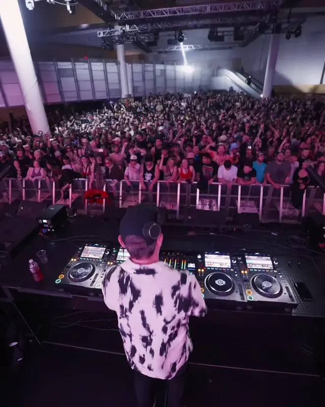 DnB Allstars: Vancouver: DJ in a patterned shirt facing a big Vancouver crowd