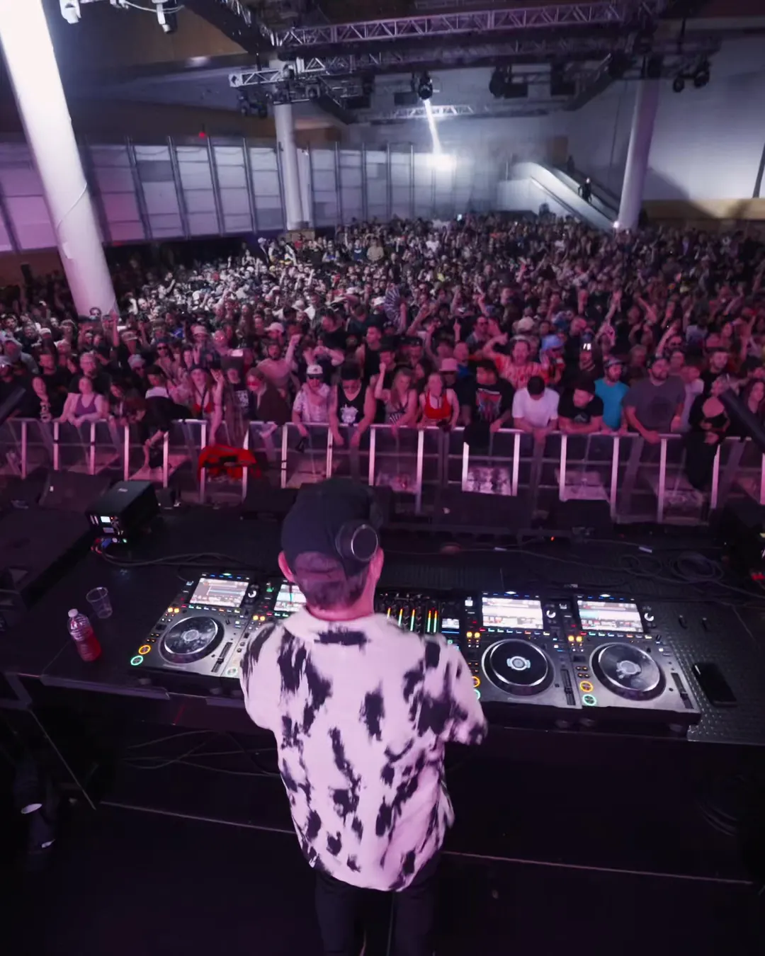 DnB Allstars: Vancouver: DJ in a patterned shirt facing a big Vancouver crowd