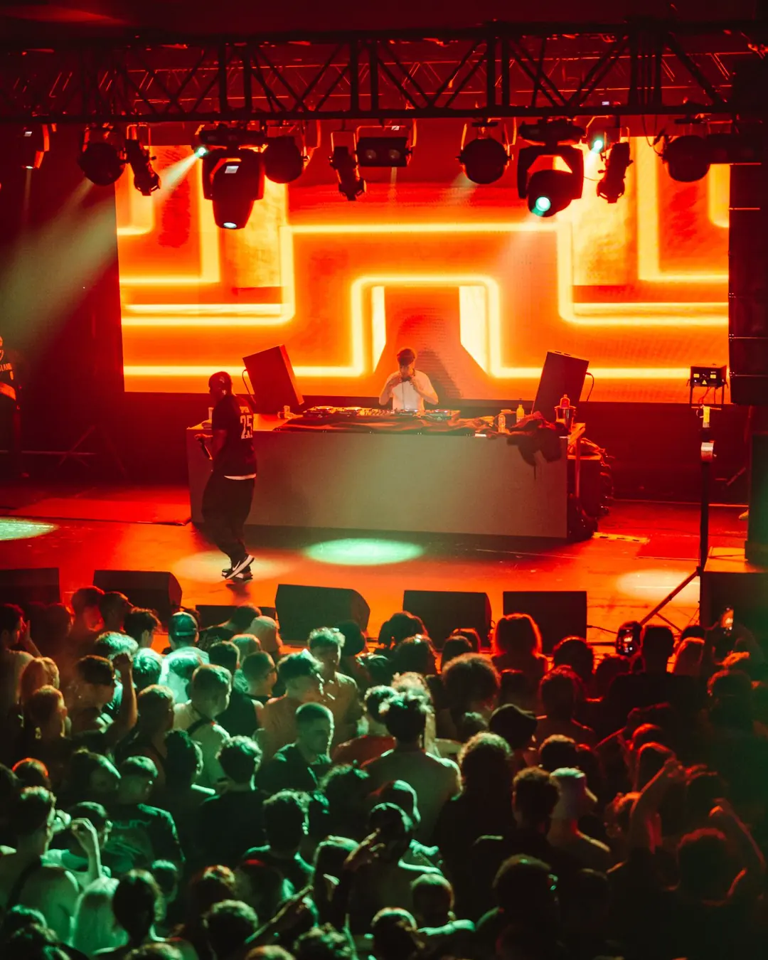 DnB Allstars x 30Hz: Birmingham: Glowing orange DnB logo over the stage, green-lit crowd packed below, bold colour