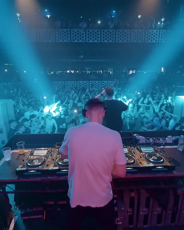 DnB Allstars x 30Hz: Bristol: DJ in white under blue lights with the Bristol crowd