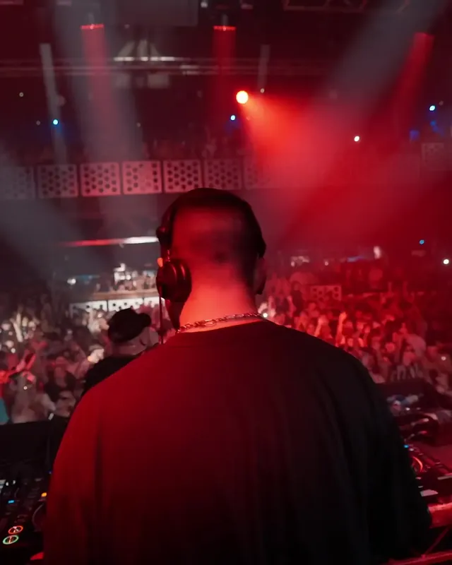 DnB Allstars x 30Hz NYE: Bristol: DJ at the decks over a red-lit NYE crowd
