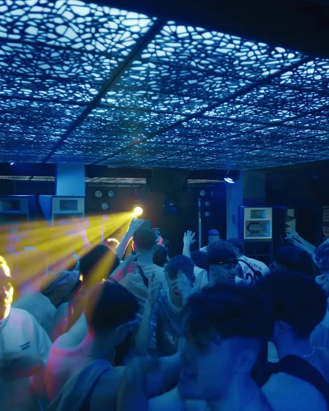 DnB Allstars x Bedlam: Cardiff: yellow beams through the Bedlam crowd under the lit ceiling