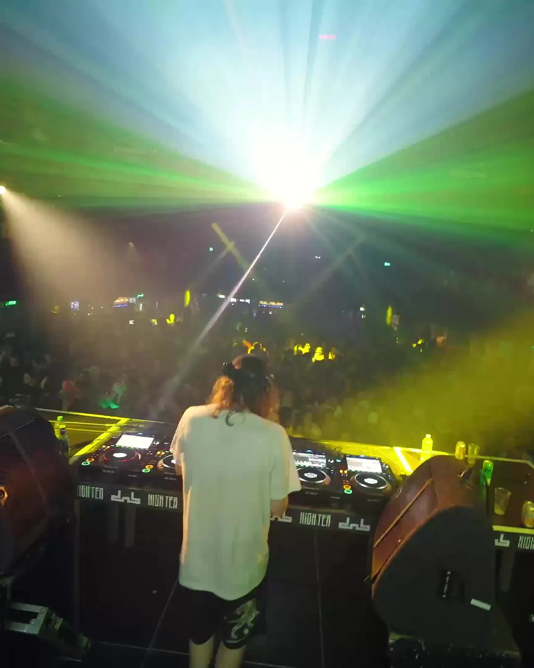 DnB Allstars x High Tea: Amsterdam: DJ facing a green-and-white light burst in Amsterdam